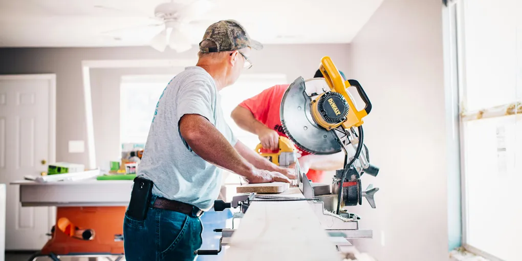 homeowner using power tools for outdoor home improvement and lawn sprinkler repair