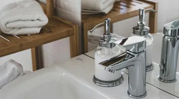 Chrome bathroom faucet mounted on a vanity sink, how to replace a bathroom faucet