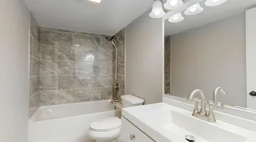 Clean white bathroom with toilet and fixtures, complete toilet repair guide for homeowners