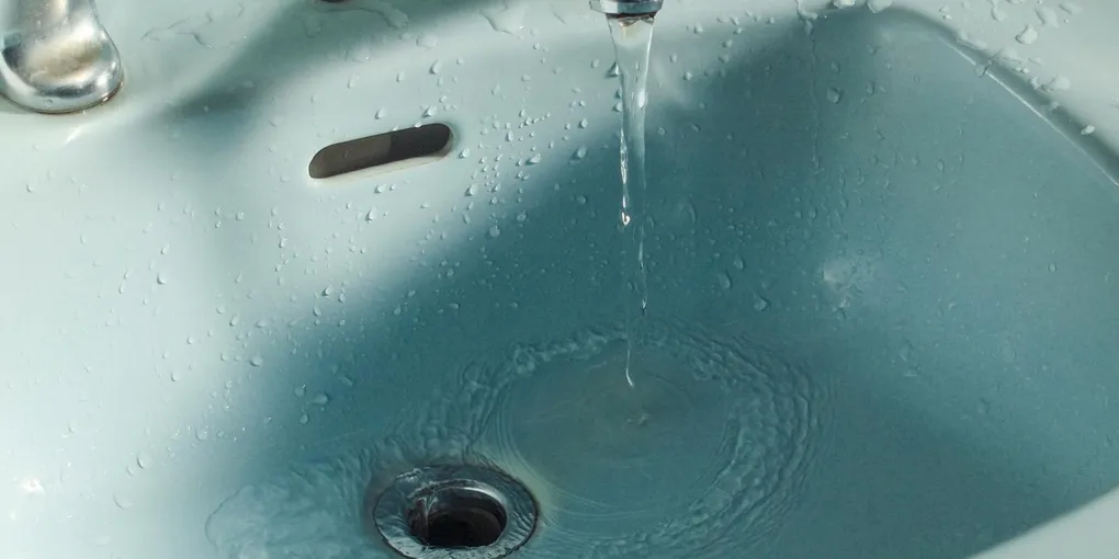 Bathroom sink with pop-up drain, common diagnostic for sink not draining or draining slow