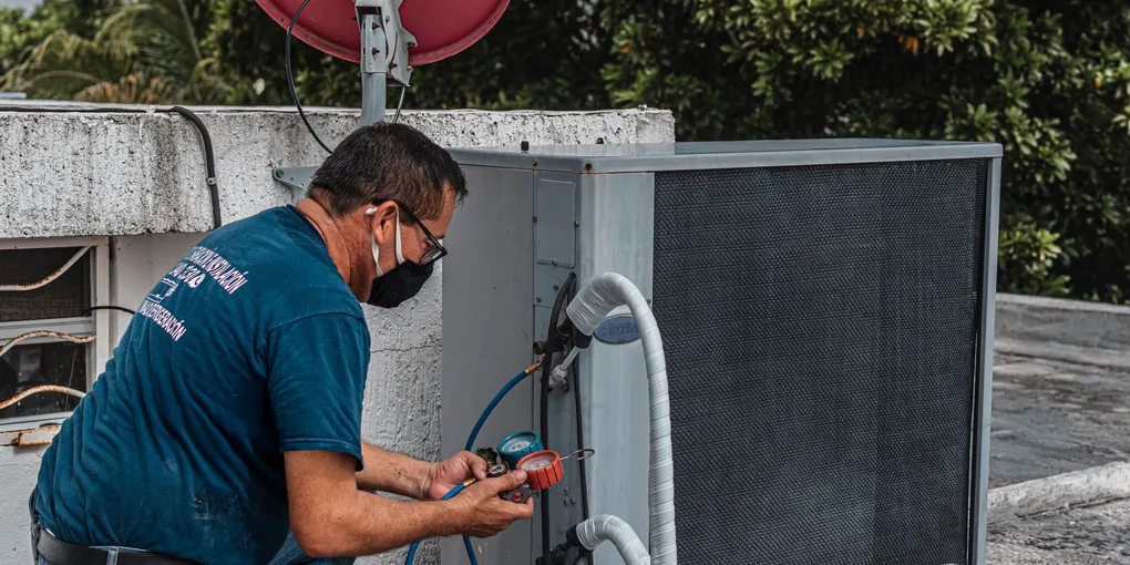 Service gauges and white PVC drain piping at an indoor AC condensate drain line