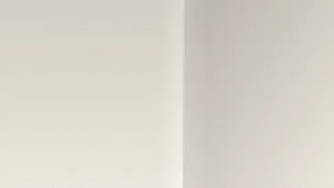 Drywall wall corner with metal corner bead where two wall surfaces meet