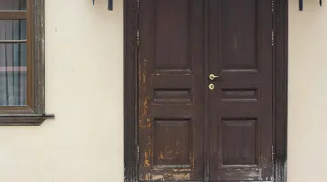 Exterior door frame with rotted wood at the base, repair guide for soft door jamb