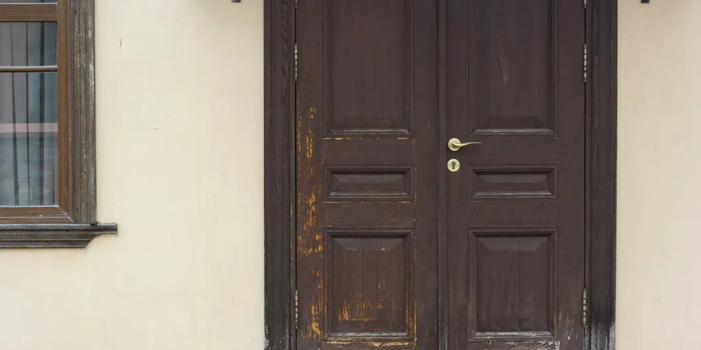 Exterior door frame with rotted wood at the base, repair guide for soft door jamb