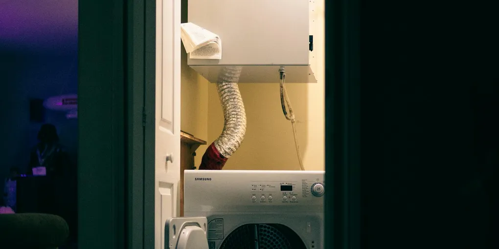 Clothes dryer in a laundry room with vent hose, how to clean a dryer vent