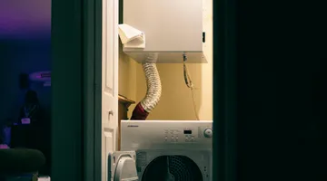 Clothes dryer in a laundry room with vent hose, how to clean a dryer vent