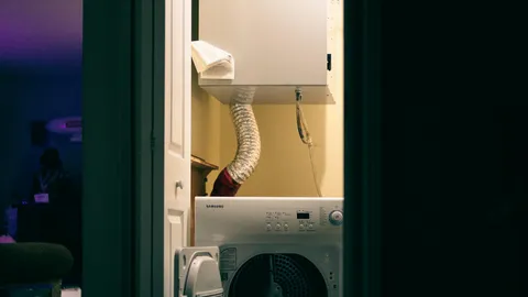 Clothes dryer in a laundry room with vent hose, how to clean a dryer vent