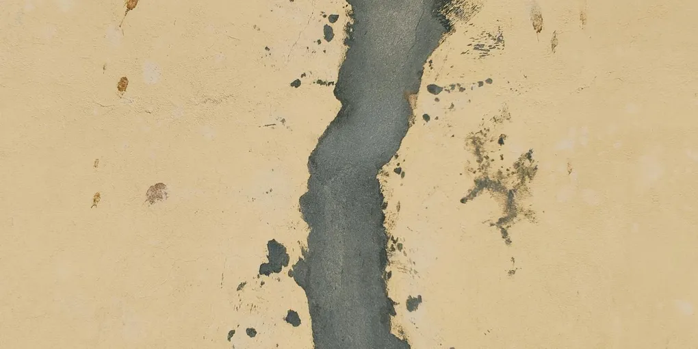 Joint compound applied along a drywall seam with a wide finishing knife