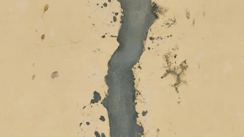 Joint compound applied along a drywall seam with a wide finishing knife
