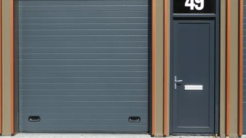 White garage door on a suburban home in afternoon light, garage door wont close fix