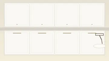 Freshly painted cream kitchen cabinets with paint roller and brush on counter
