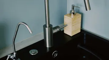 Stainless steel kitchen sink with running water, unclogging a kitchen sink without chemicals