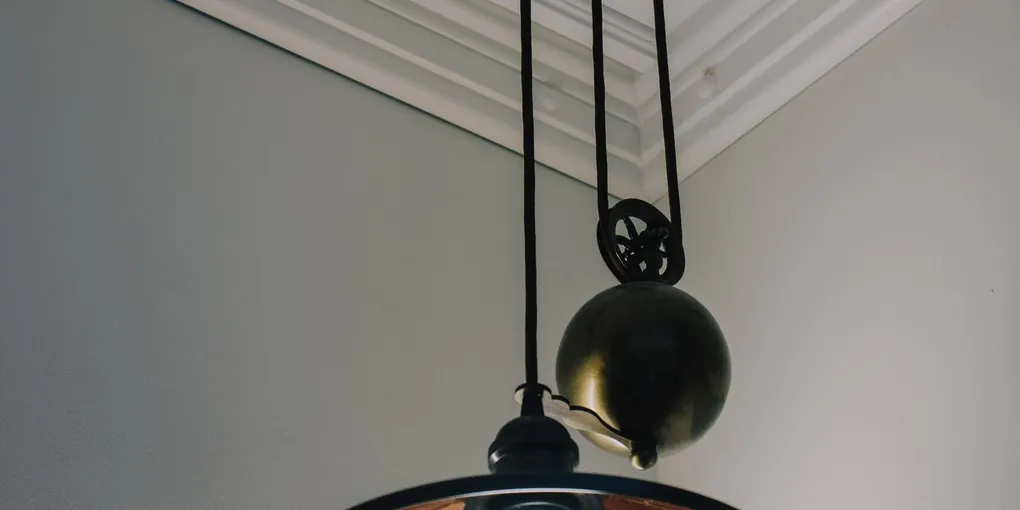 Lit pendant ceiling light fixture in a home interior with flickering lights