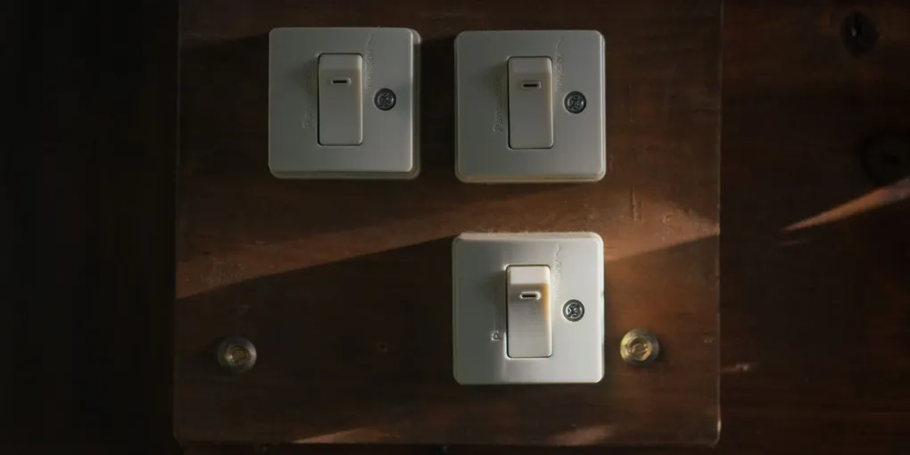 Three white toggle wall switches on plates, how to replace a light switch