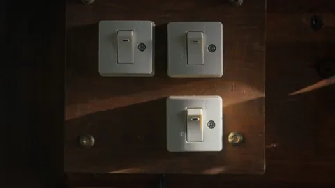 Three white toggle wall switches on plates, how to replace a light switch