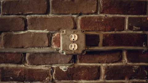 Outdoor outlet receptacle in a metal box on a brick exterior wall that stopped working