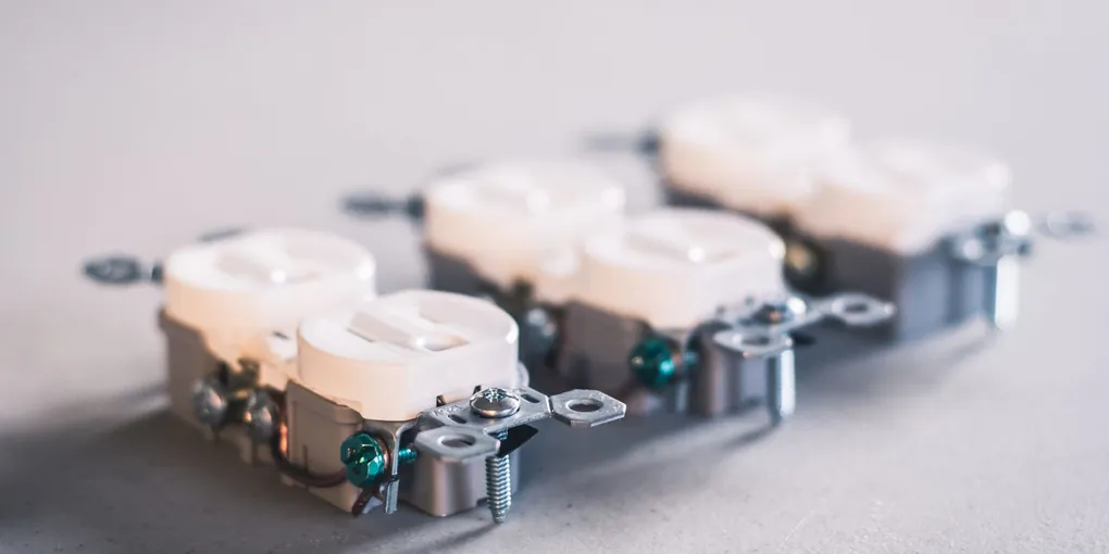 Close-up of white US duplex receptacles, the same body style as a GFCI outlet