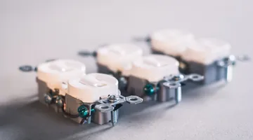 Close-up of white US duplex receptacles, the same body style as a GFCI outlet