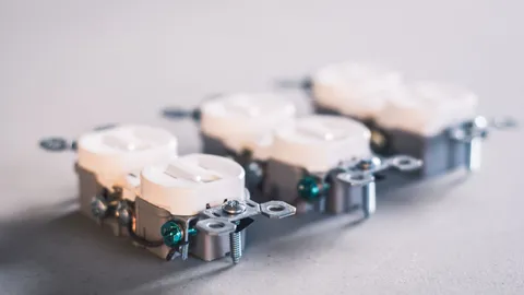 Close-up of white US duplex receptacles, the same body style as a GFCI outlet