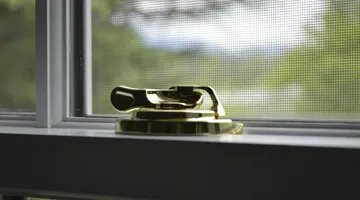Person cleaning a dirty window screen by hand, cleaning window screens without damaging them